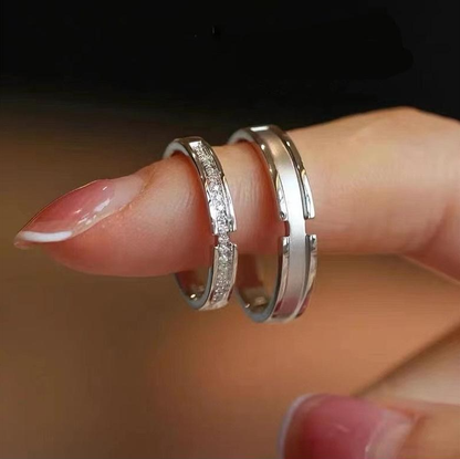 Couple ring set displayed on a finger, featuring sterling silver and moissanite for his and hers promise.